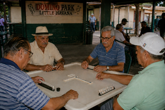 Older men playing dominoes around a table at Domino Park in Little Havana.