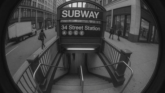 Fisheye security camera view of a New York subway entrance with pedestrians walking by, used in an advertising blog to illustrate city movement and public spaces