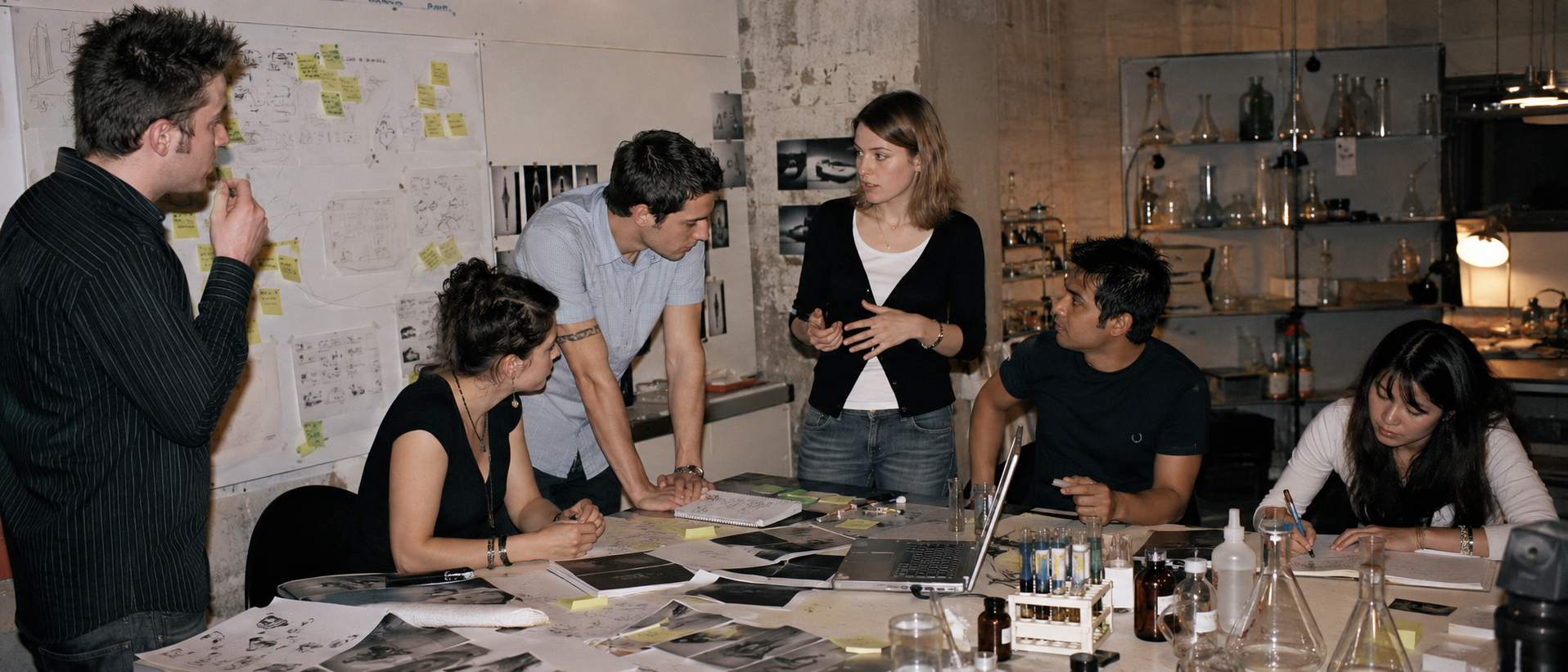 Marketing team brainstorming advertising concepts in a creative office with notes, research materials, and lab equipment.